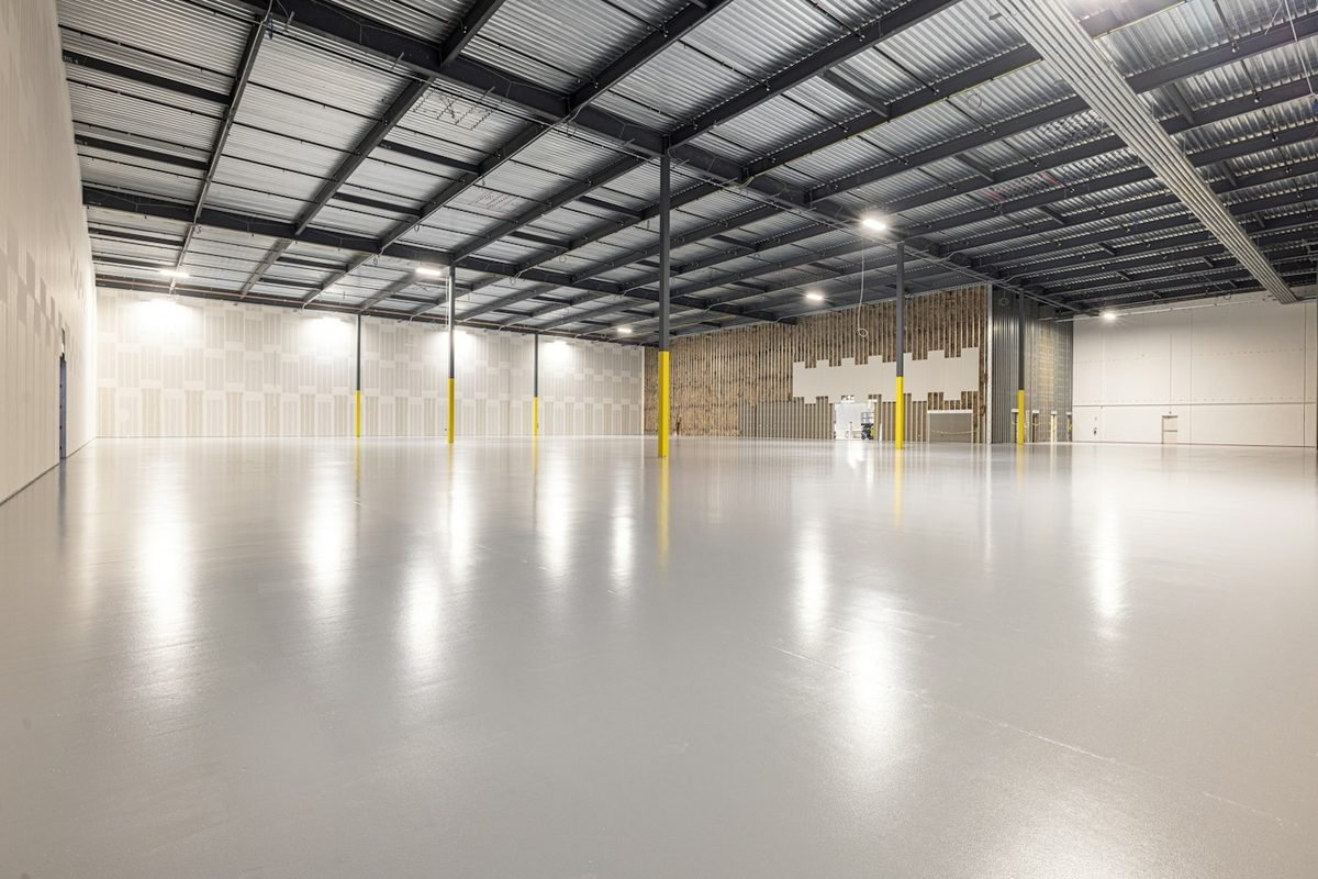 A large empty commercial unit with a concrete floor