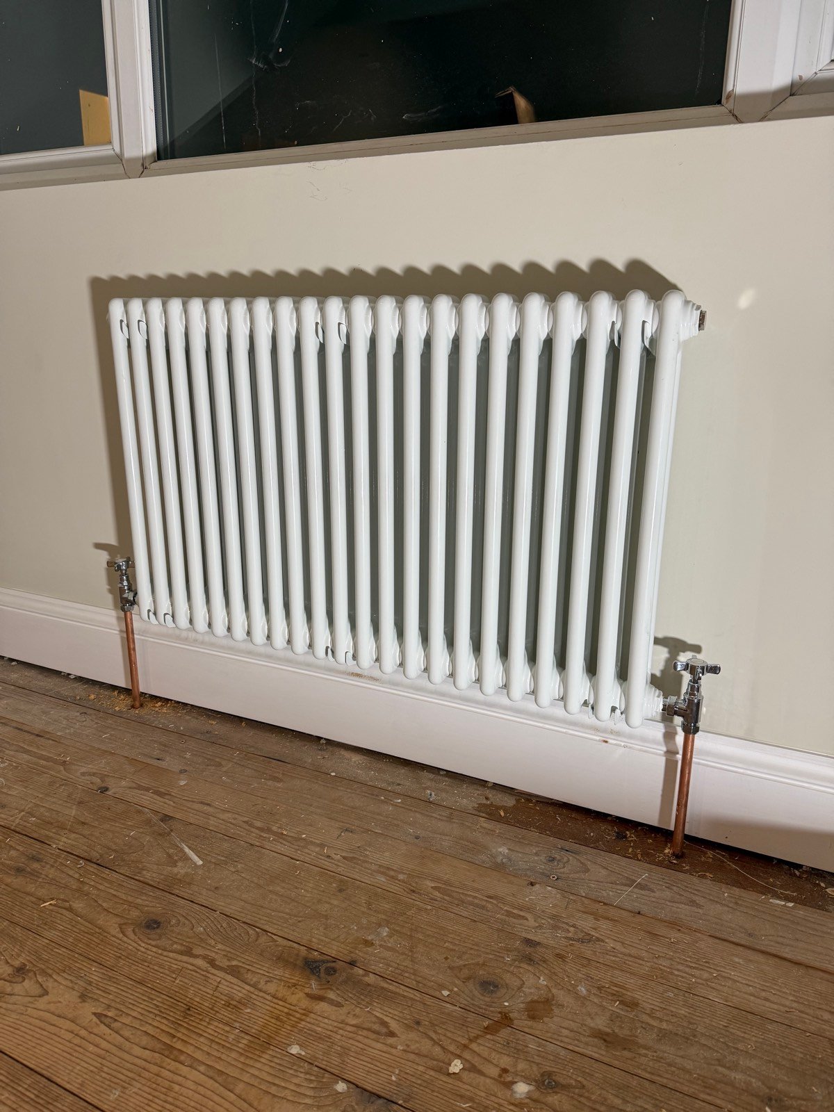 White column radiator installation with copper valves