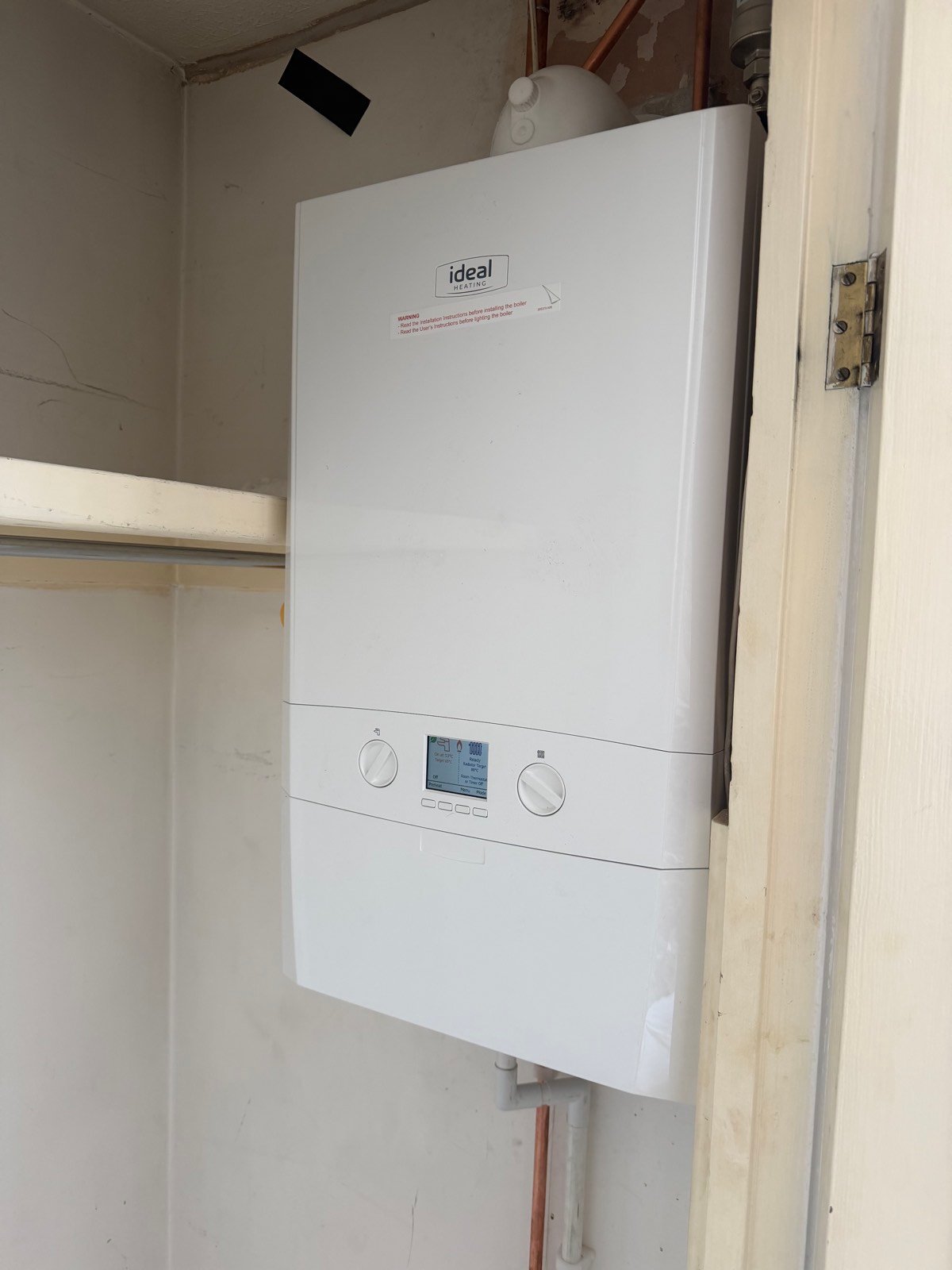 Compact combi boiler fitted neatly into an airing cupboard